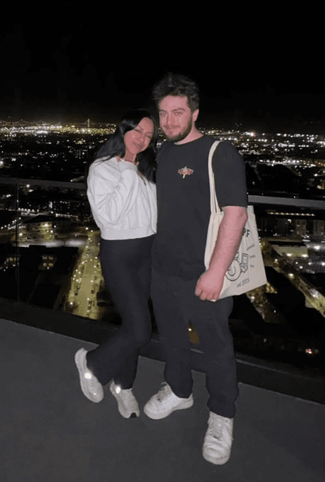Michalis and Cristal on a San Francisco rooftop at night